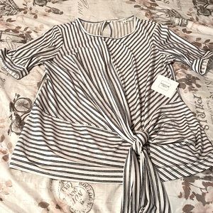 Small black and white blouse with tie on the bottom of blouse